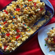 Movie Theater Popcorn Cake in a blue serving dish, with a slice on a white plate beside it